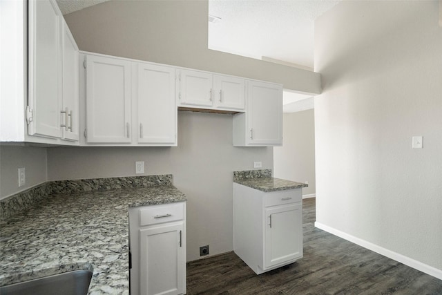 kitchen featuring a sink, baseboards, white cabinets, and dark wood-style flooring