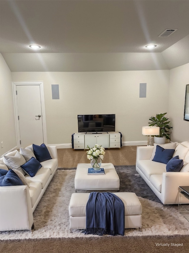 carpeted living area with baseboards, visible vents, vaulted ceiling, and recessed lighting