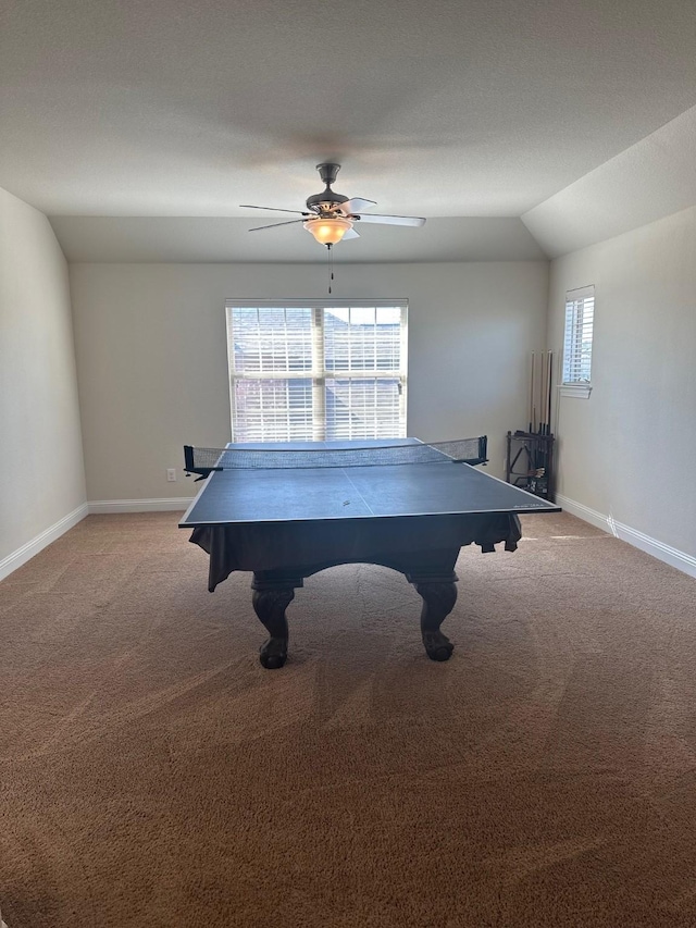 rec room with lofted ceiling, light colored carpet, ceiling fan, and baseboards