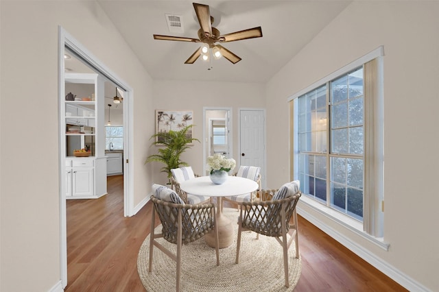 dining area with visible vents, wood finished floors, a wealth of natural light, and baseboards