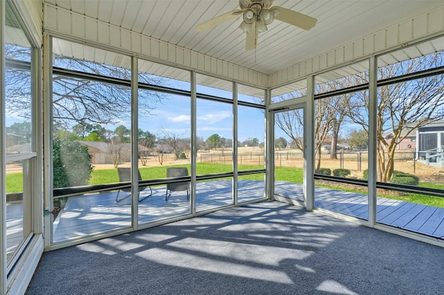 unfurnished sunroom featuring a ceiling fan