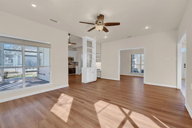 unfurnished living room with light wood finished floors, a ceiling fan, visible vents, and recessed lighting