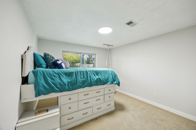 bedroom featuring visible vents, light carpet, and baseboards