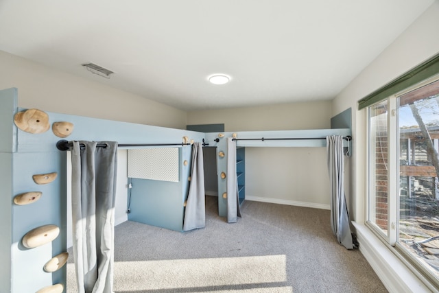 carpeted bedroom featuring visible vents