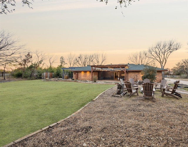 view of yard with a patio area, a fire pit, and a pergola