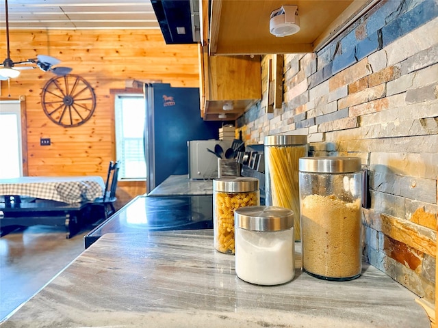 kitchen featuring wood walls and stove