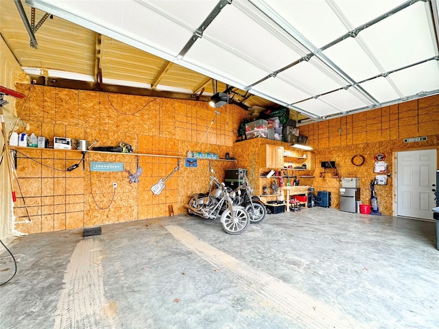 garage with a workshop area and a garage door opener