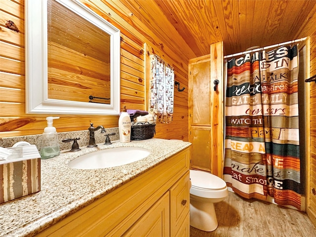 bathroom with toilet, a shower with curtain, wood ceiling, wood finished floors, and vanity