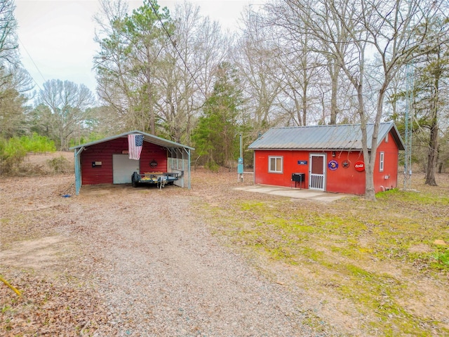 view of outbuilding featuring an outbuilding and dirt driveway