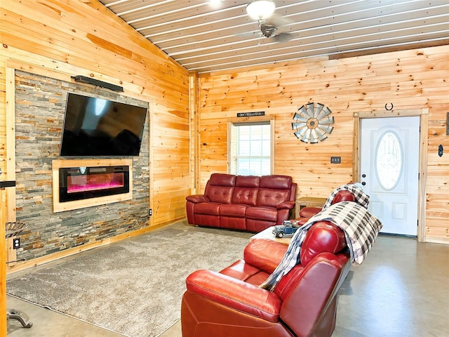 living area with wooden ceiling, a fireplace, and wooden walls