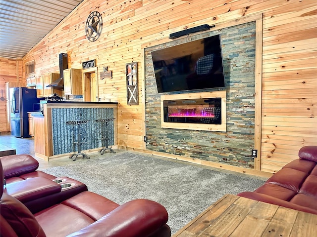 living room featuring wooden walls and high vaulted ceiling