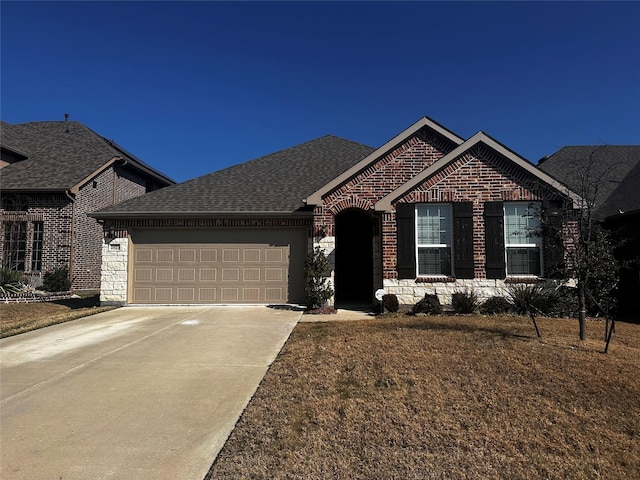 single story home with a garage, concrete driveway, brick siding, and a shingled roof