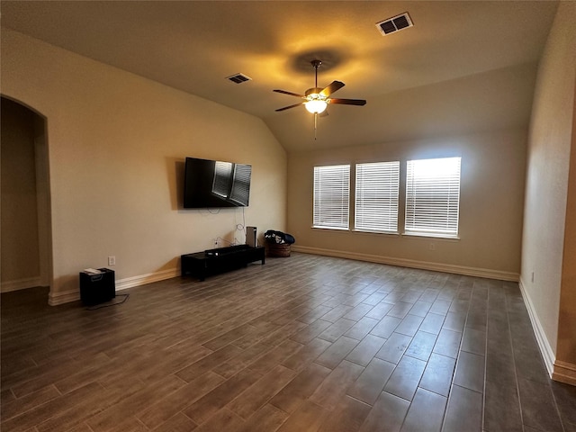 unfurnished living room with a ceiling fan, arched walkways, visible vents, and dark wood-type flooring