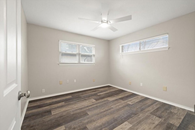 empty room with a ceiling fan, dark wood-style flooring, and baseboards