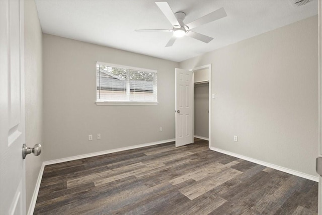 unfurnished bedroom with ceiling fan, baseboards, and wood finished floors