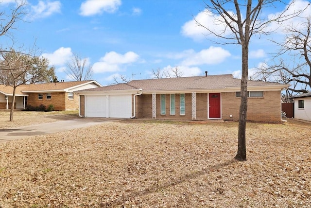 ranch-style home with concrete driveway, brick siding, and an attached garage