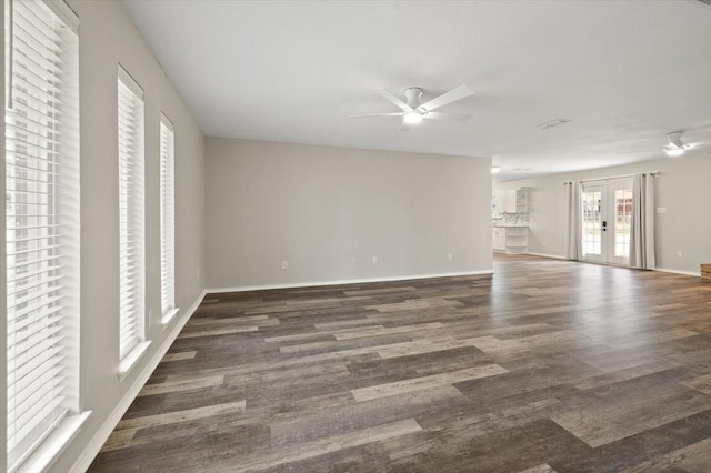 unfurnished room featuring french doors, ceiling fan, baseboards, and wood finished floors