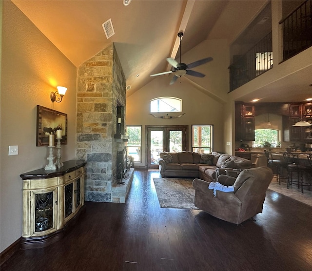 living room with high vaulted ceiling, visible vents, a wealth of natural light, and wood finished floors