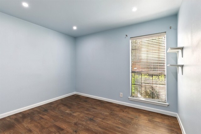 unfurnished room featuring baseboards, recessed lighting, and hardwood / wood-style flooring