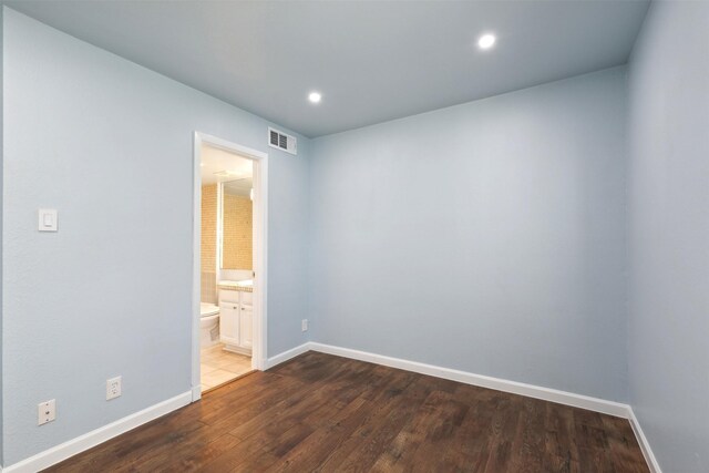 empty room featuring baseboards, visible vents, wood finished floors, and recessed lighting