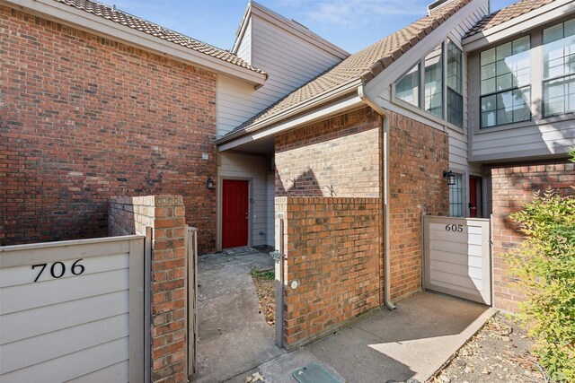 doorway to property with brick siding