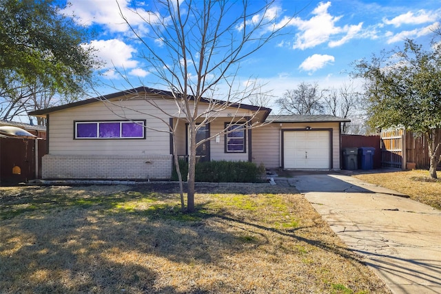 ranch-style house featuring brick siding, a front yard, fence, a garage, and driveway