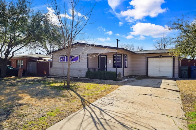 single story home with a garage, driveway, brick siding, and a porch