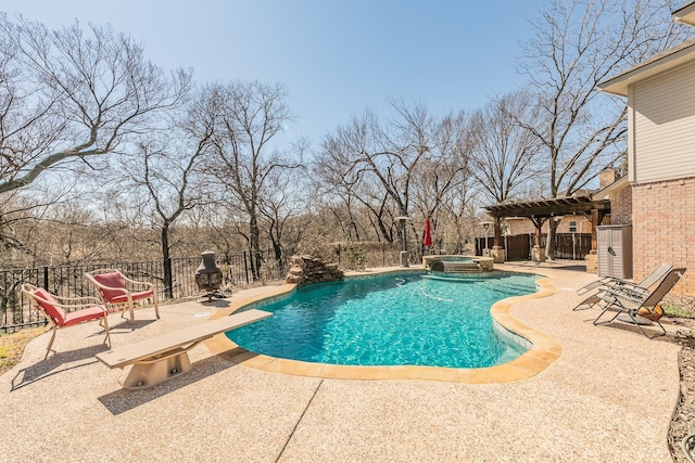 view of swimming pool with a patio, a fenced backyard, and a pool with connected hot tub