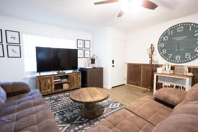 living room with ceiling fan, wood finished floors, and crown molding