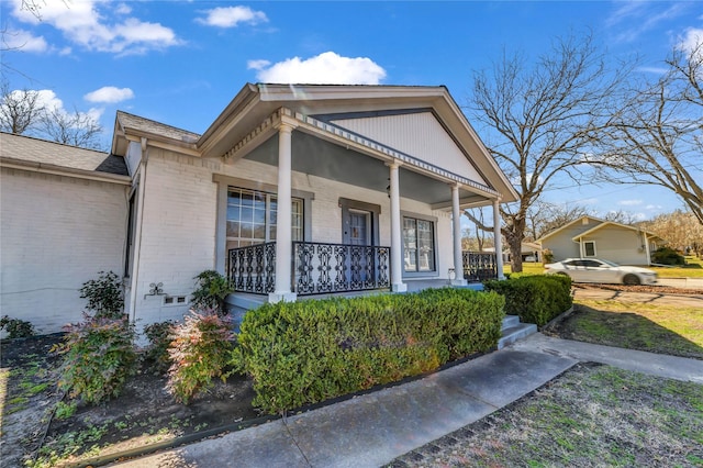 view of front of property with brick siding and a porch