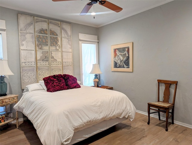 bedroom featuring light wood finished floors, baseboards, and ornamental molding