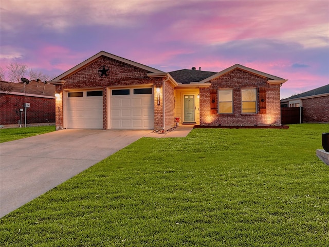 single story home featuring an attached garage, concrete driveway, brick siding, and a front yard