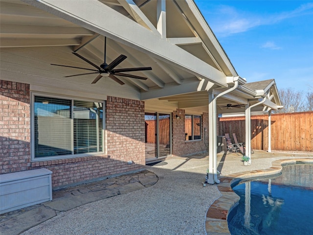 view of patio featuring a ceiling fan, a fenced in pool, and fence