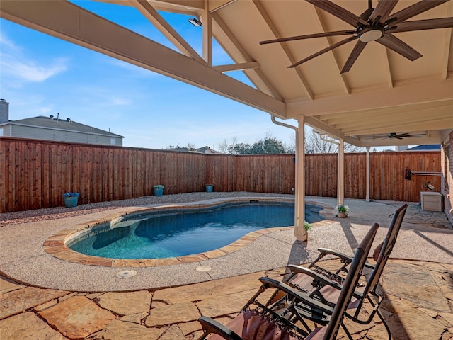 view of swimming pool featuring a ceiling fan, a patio area, a fenced backyard, and a fenced in pool