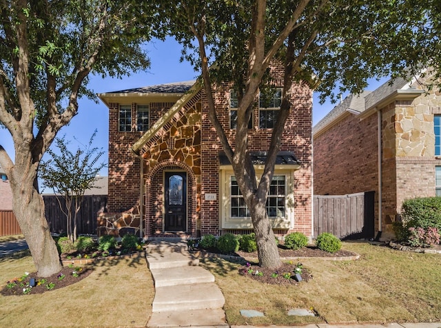 view of front of house with brick siding and fence