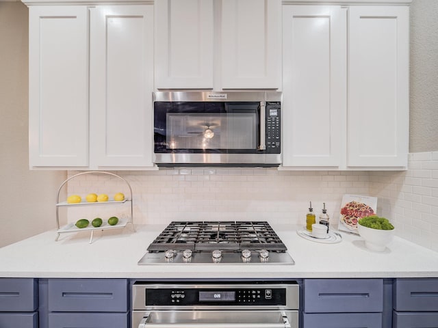 kitchen featuring stainless steel appliances, light countertops, and gray cabinetry