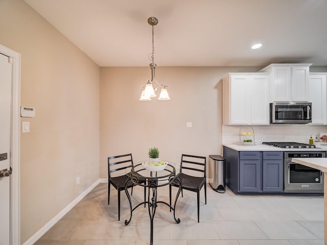 kitchen featuring tasteful backsplash, baseboards, white cabinets, stainless steel appliances, and light countertops