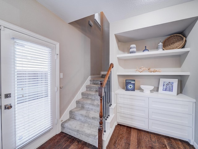 stairway with baseboards and wood finished floors