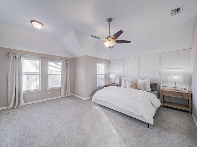 bedroom featuring carpet flooring, a ceiling fan, visible vents, vaulted ceiling, and baseboards