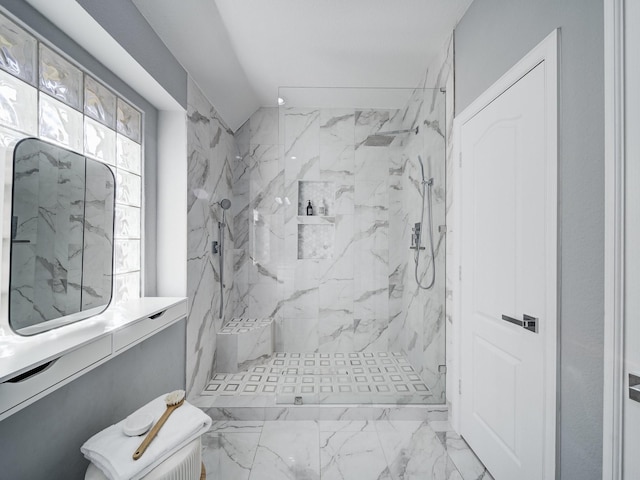 bathroom featuring marble finish floor and a marble finish shower