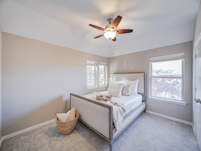 bedroom with ceiling fan, carpet flooring, and baseboards