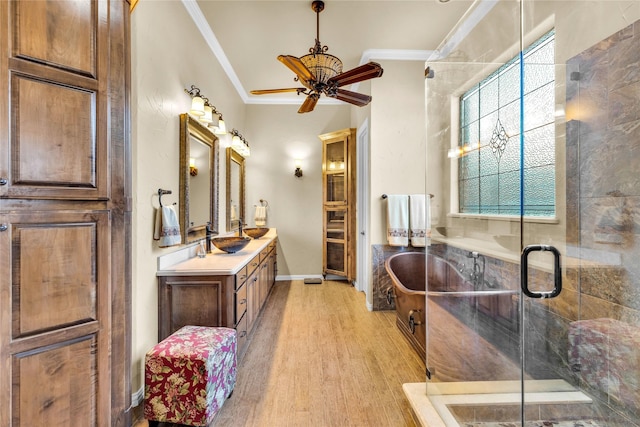 full bathroom with crown molding, a stall shower, vanity, wood finished floors, and baseboards