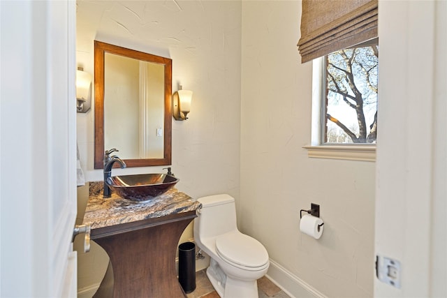 bathroom with toilet and vanity