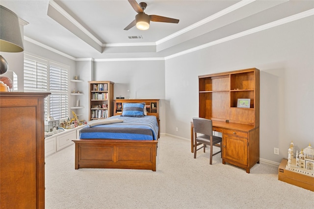 bedroom with carpet floors, visible vents, baseboards, ornamental molding, and a raised ceiling