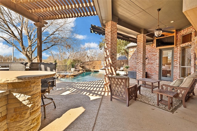 view of patio / terrace featuring a pool with connected hot tub, a fenced backyard, outdoor dry bar, and a pergola