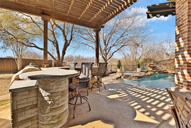 view of patio / terrace with an outdoor kitchen, a fenced backyard, an in ground hot tub, outdoor dry bar, and a fenced in pool