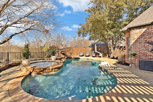 view of pool with a fenced backyard, a pool with connected hot tub, and cooling unit