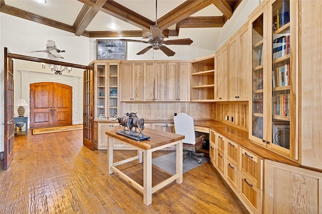 office featuring a high ceiling, coffered ceiling, hardwood / wood-style floors, and built in study area