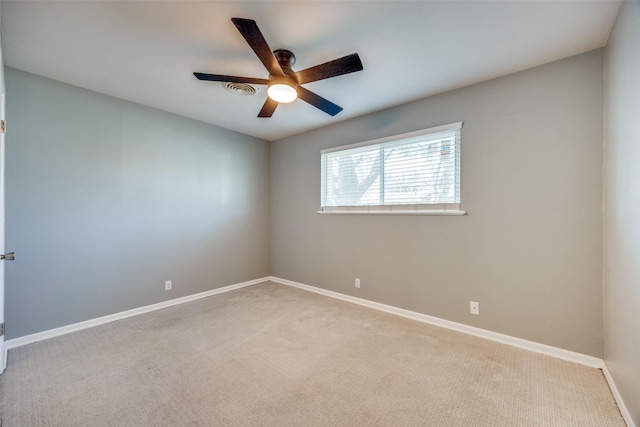 carpeted empty room featuring visible vents, baseboards, and a ceiling fan