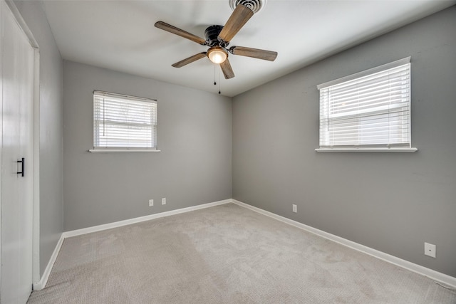 unfurnished room featuring carpet flooring, a ceiling fan, and baseboards